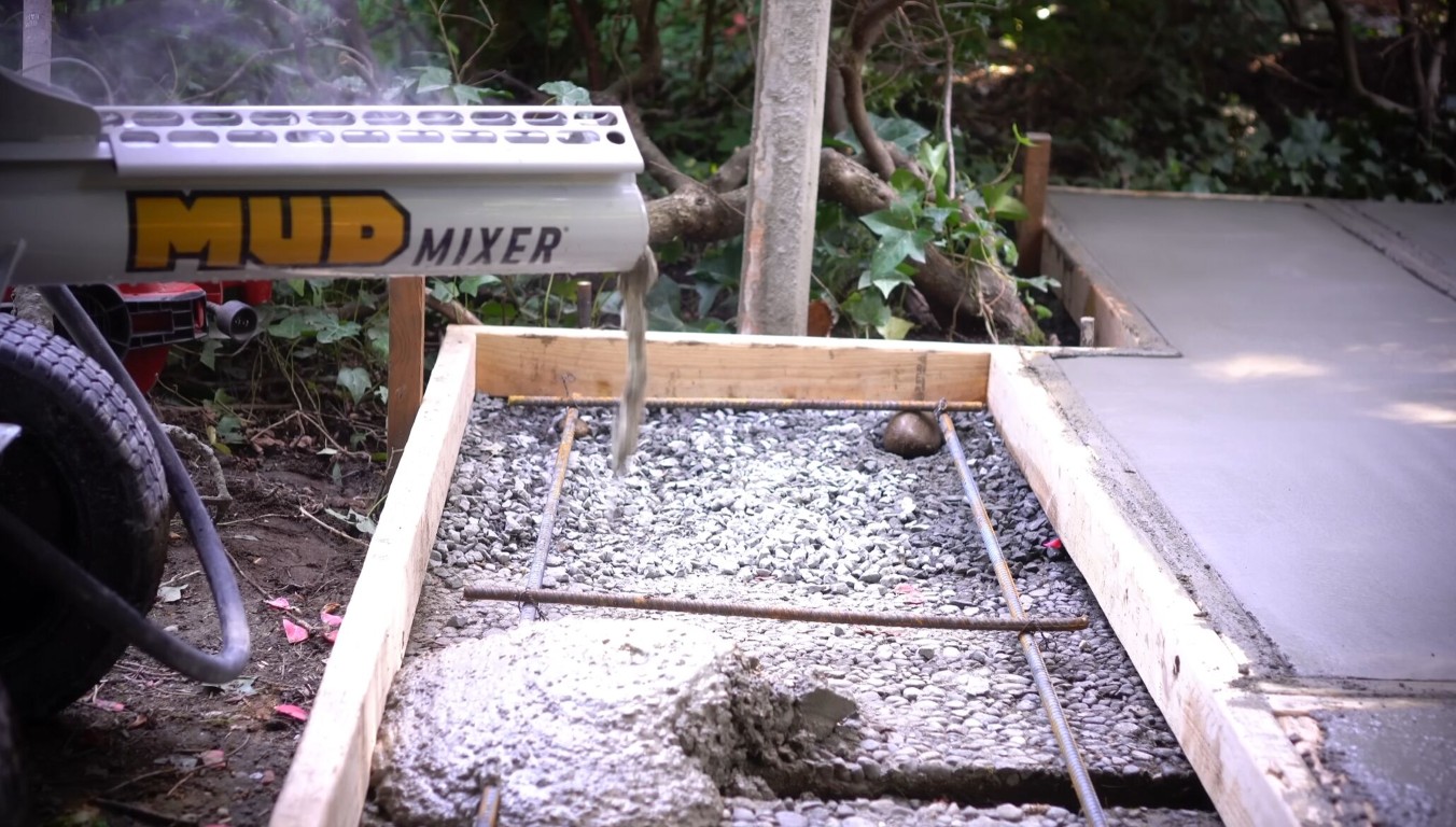 Concrete slab leveling preparation showing gravel base and rebar reinforcement before pouring